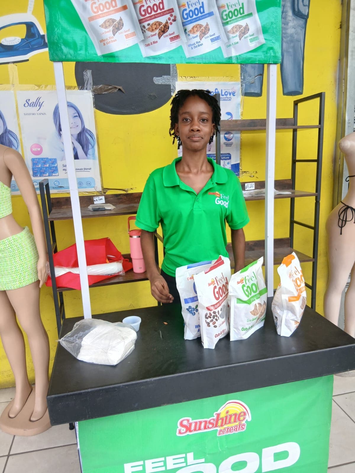Brand ambassador standing behind a Sunshine Feel Good retail product display.